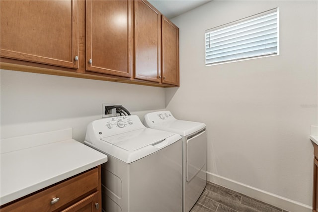 washroom featuring cabinet space, baseboards, dark wood finished floors, and washer and dryer