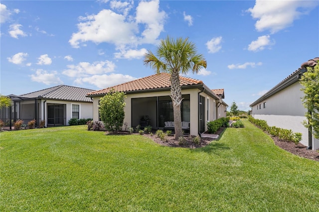 back of house featuring a lawn, a tile roof, and stucco siding