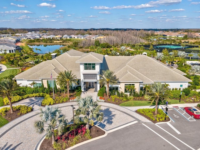 view of property featuring uncovered parking and a water view