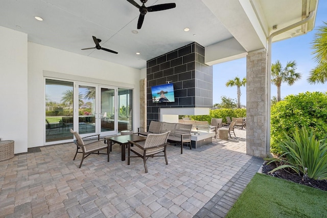 view of patio / terrace with a ceiling fan, french doors, and an outdoor living space