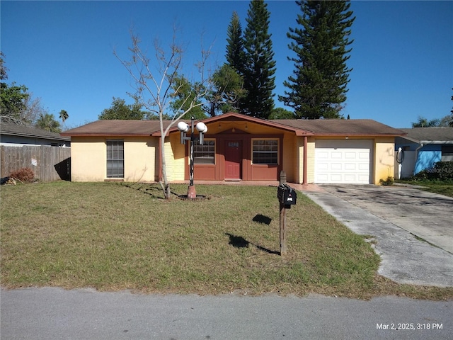 ranch-style home with stucco siding, an attached garage, a front yard, and fence