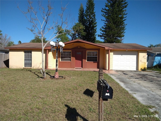 single story home with a garage, stucco siding, driveway, and a front lawn