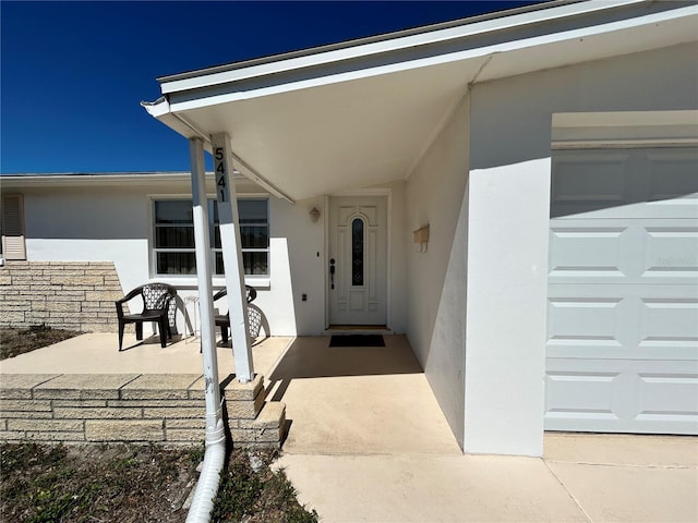 entrance to property with stucco siding