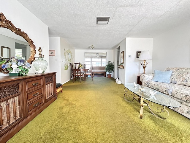 interior space with light carpet, a textured ceiling, and visible vents