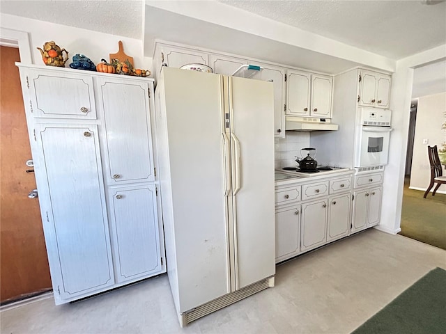 kitchen featuring light countertops, decorative backsplash, white cabinetry, white appliances, and under cabinet range hood