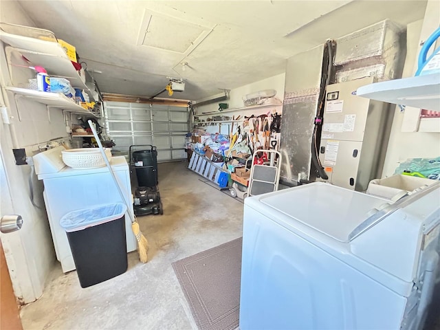 garage with washing machine and clothes dryer and a garage door opener