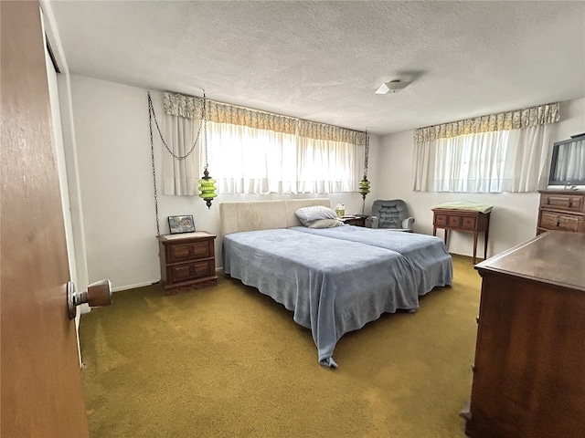 carpeted bedroom with a textured ceiling