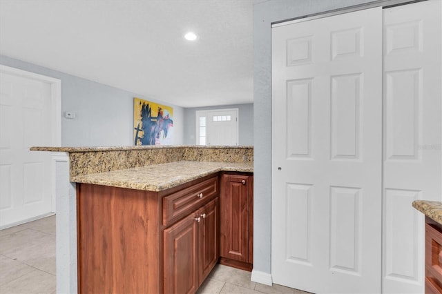 kitchen with light stone counters and light tile patterned floors