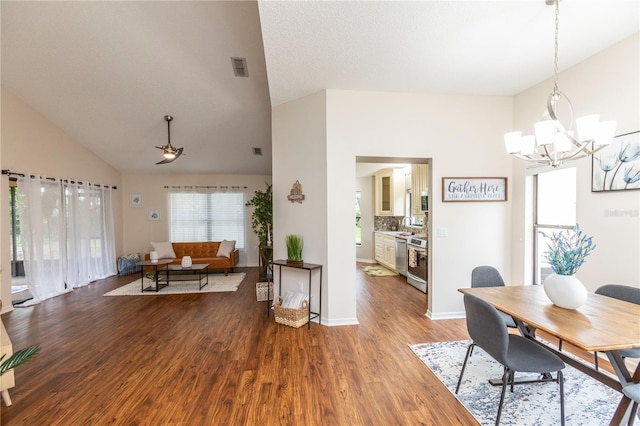 dining room with visible vents, an inviting chandelier, wood finished floors, high vaulted ceiling, and baseboards