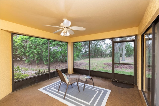 sunroom / solarium with a ceiling fan and plenty of natural light