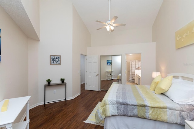 bedroom with ensuite bathroom, a ceiling fan, wood finished floors, high vaulted ceiling, and baseboards