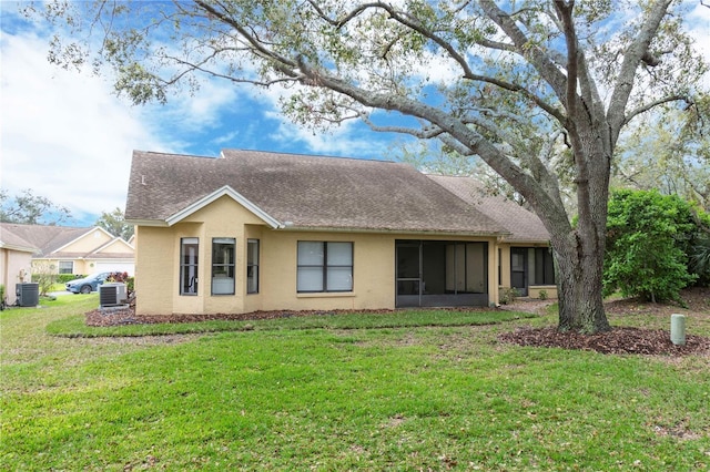 back of property featuring a yard, roof with shingles, cooling unit, and stucco siding