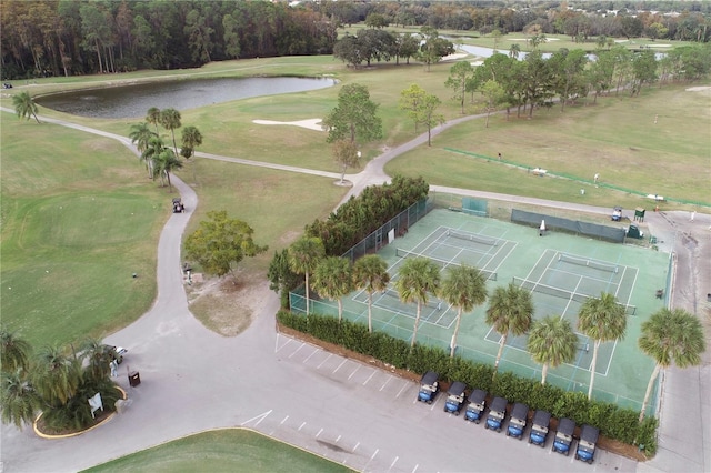 drone / aerial view featuring view of golf course and a water view