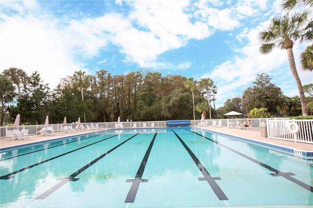 pool featuring a patio area and fence