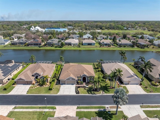 drone / aerial view with a residential view and a water view