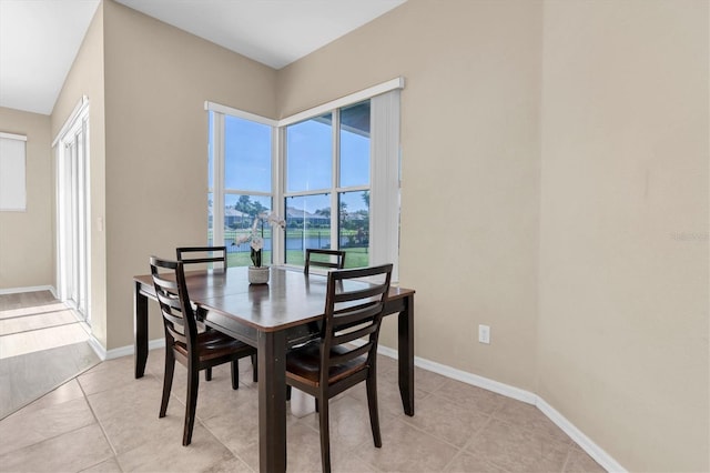 dining room with light tile patterned floors and baseboards