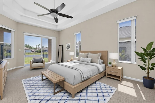 bedroom with baseboards, a raised ceiling, light colored carpet, and access to outside