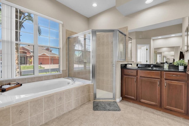 full bathroom with tile patterned floors, vanity, a bath, and a shower stall