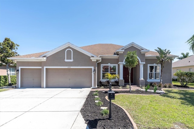 ranch-style house with stucco siding, a front lawn, concrete driveway, and an attached garage