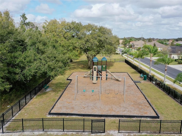 view of community with playground community, a yard, and fence