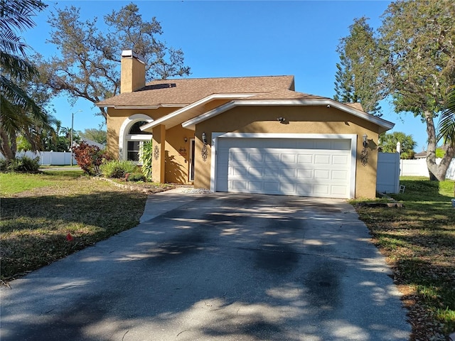 view of front of property with stucco siding, fence, concrete driveway, an attached garage, and a chimney