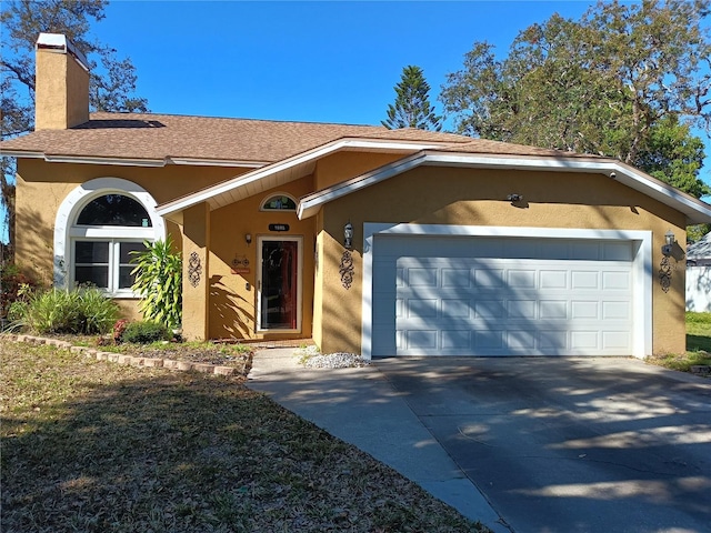 ranch-style home with a shingled roof, concrete driveway, stucco siding, a chimney, and an attached garage