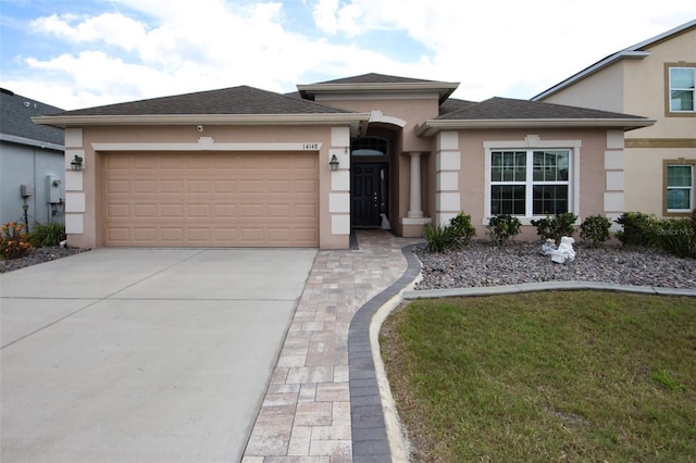 prairie-style house with driveway, a shingled roof, a garage, and stucco siding