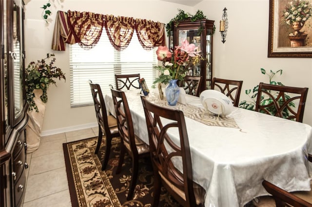 dining room with light tile patterned flooring and baseboards