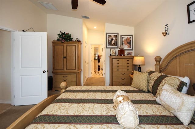 bedroom with vaulted ceiling, visible vents, and a ceiling fan