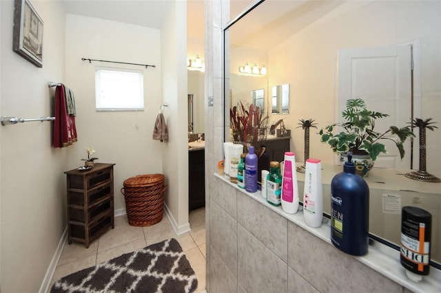 bathroom featuring tile patterned flooring, vanity, and baseboards