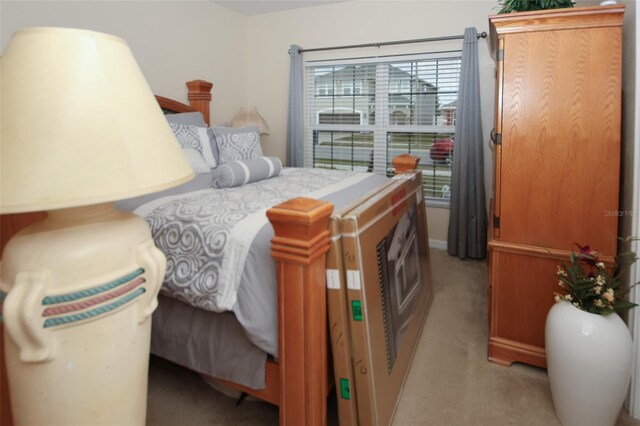 bedroom featuring light carpet