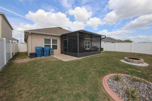 back of house with an outdoor fire pit, a lawn, a sunroom, a fenced backyard, and stucco siding