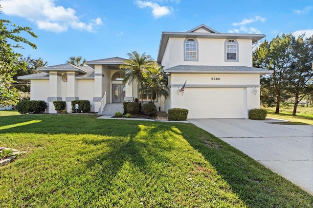 view of front facade featuring driveway, an attached garage, a front lawn, and stucco siding