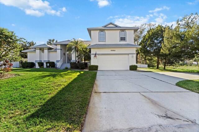 view of front of house with driveway, a garage, a front lawn, and stucco siding