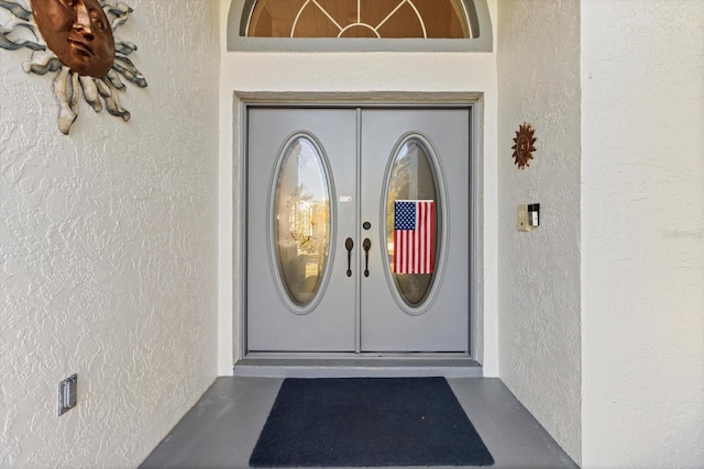 entrance to property with stucco siding