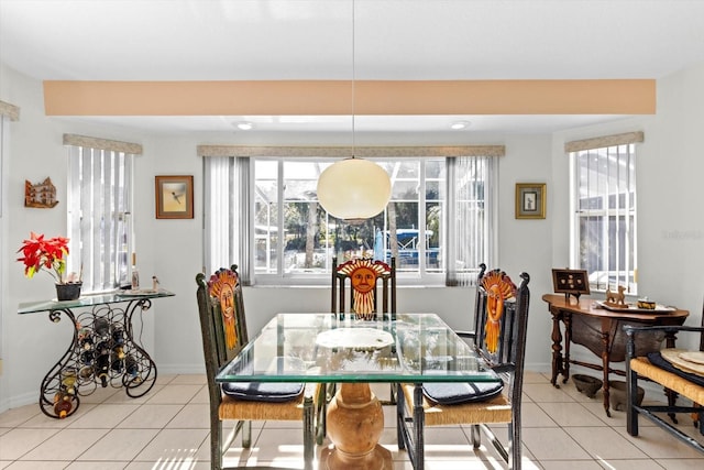 dining room featuring light tile patterned floors and baseboards