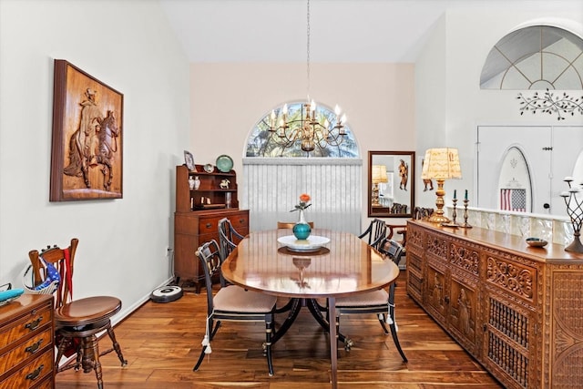 dining room featuring lofted ceiling, a notable chandelier, and wood finished floors