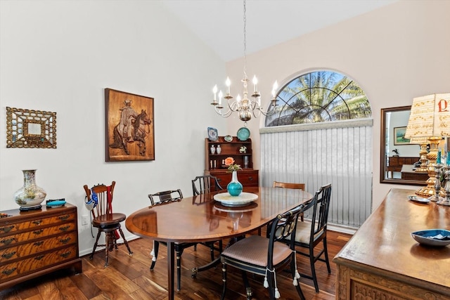 dining space with dark wood-style floors, high vaulted ceiling, and an inviting chandelier