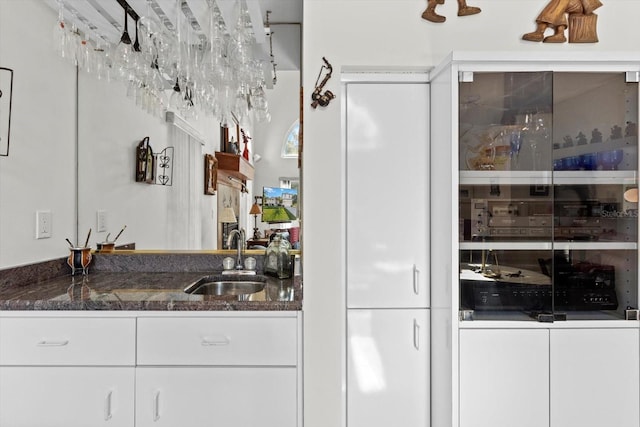 bar featuring indoor wet bar and a sink