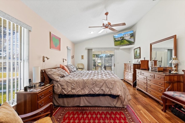 bedroom featuring vaulted ceiling, wood finished floors, and access to exterior