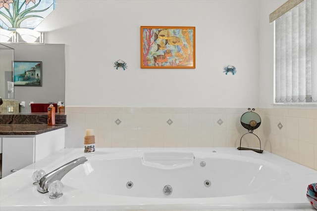 full bathroom featuring a healthy amount of sunlight and a whirlpool tub