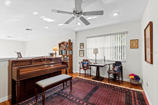 sitting room with baseboards, visible vents, wood finished floors, and recessed lighting