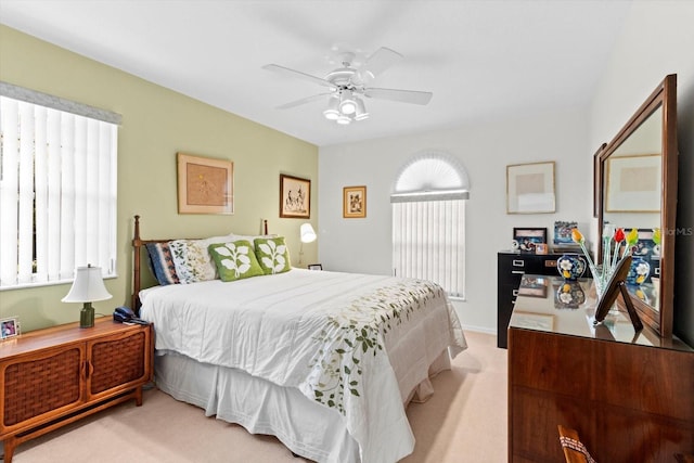 bedroom with light carpet and ceiling fan