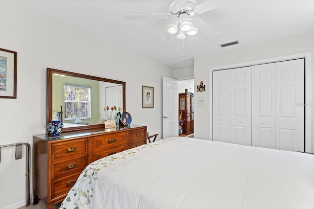 bedroom with a closet, visible vents, and a ceiling fan