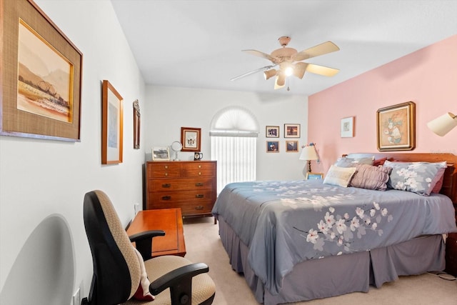 bedroom with a ceiling fan and light colored carpet