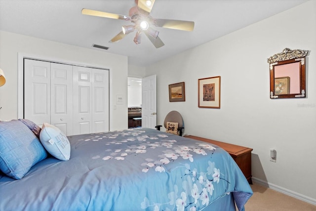 bedroom with baseboards, visible vents, ceiling fan, carpet floors, and a closet