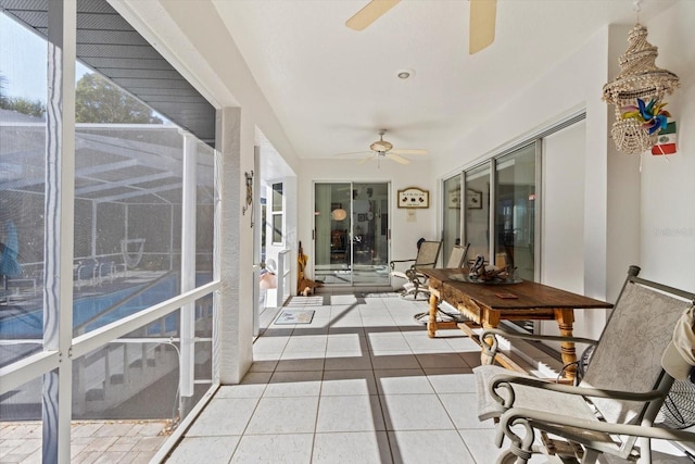 sunroom featuring a ceiling fan