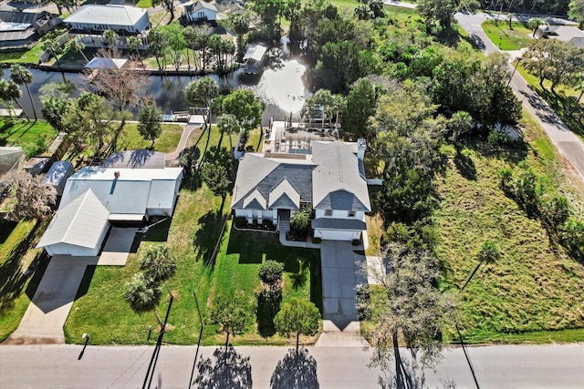 drone / aerial view with a water view and a residential view