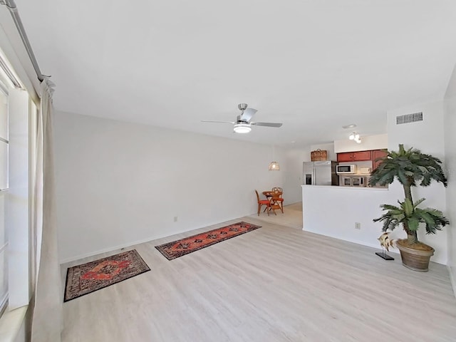 entrance foyer featuring light wood-type flooring, visible vents, and a ceiling fan