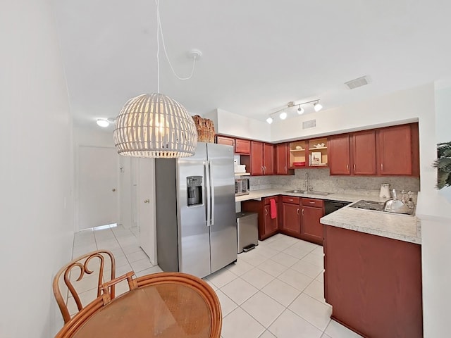 kitchen featuring stainless steel appliances, light countertops, decorative backsplash, light tile patterned flooring, and a sink